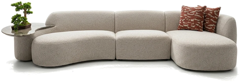 A curved bouclé sectional sofa with a stone side table and rust cushions